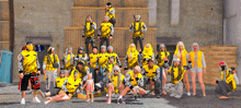 a large group of people are posing for a picture and one of them is wearing a yellow shirt that says ' ao '