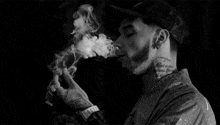 a man with a tattoo on his neck is smoking a cigar