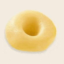 a close up of a donut with a hole in the middle on a white surface .