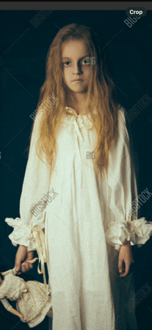 a girl in a white nightgown is holding a stuffed animal