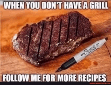 a steak is on a cutting board next to a marker .