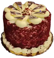 a red velvet cake with white frosting and chocolate on top