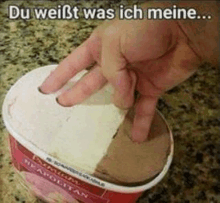 a hand is reaching into a container of ice cream with the words du weißt was ich meine written above it .