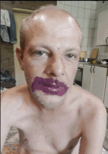 a shirtless man with purple paint on his face