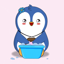 a penguin with a flower on its head is sitting in a blue bowl of water