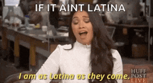 a woman is sitting on a couch with her mouth open and says if it aint latina