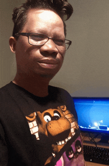 a man wearing glasses and a black shirt with a picture of foxy