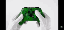 a person wearing white gloves is holding an xbox controller