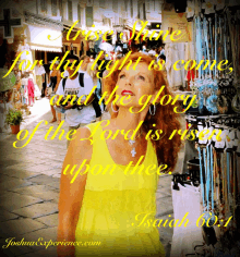 a woman in a yellow dress stands in front of a sign that says " the glory of the lord is rising "