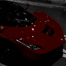 a red ferrari sports car is parked on a street