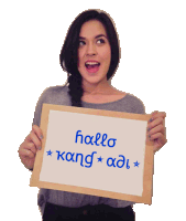 a woman is holding up a sign that says hallo kang ad