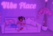 two girls laying on a couch under a vibe place neon sign