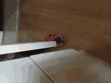 a pair of pink slippers are sitting on a wooden floor