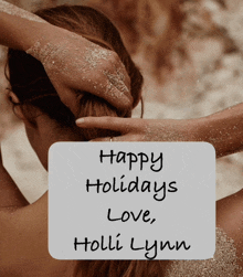 a sign that says happy holidays love holli lynn with a woman in the background