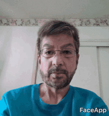 a man with glasses and a beard wears a blue shirt that says faceapp on it