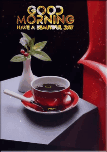 a cup of coffee sits on a saucer next to a vase of flowers with the words good morning have a beautiful day