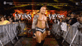 a man in a wrestling ring with the words " in my veins " behind him