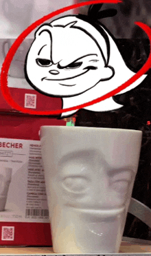 a becher mug with a face on it next to a box