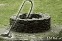 a vacuum cleaner is being used to clean a stone well ..