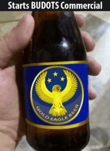 a bottle of gold eagle beer has a blue label