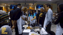 a group of people standing around a table with the words " the art of fufu " on the top