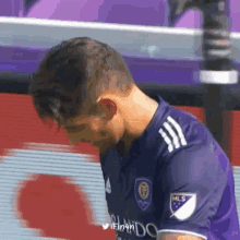 a man in a purple jersey with the word mls on the sleeve