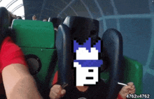 a person is riding a roller coaster with a pixelated image of a castle behind them