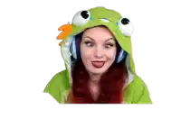 a woman with red hair is wearing a green frog hoodie