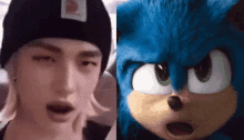 a close up of a person wearing a beanie next to a close up of a blue stuffed animal .