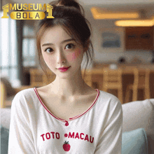 a woman wearing a white shirt that says toto macau on it