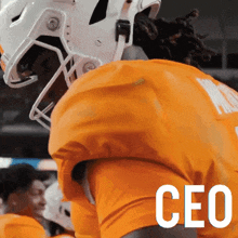 a football player wearing a white helmet and an orange shirt with the word ceo on the bottom right