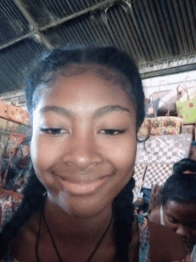 a girl with pigtails is smiling in front of a display of baskets