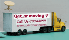 a qatar moving truck with a table on top