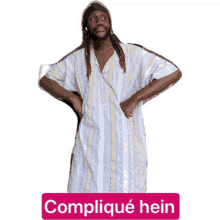 a man in a striped shirt with the word complique hein written on the bottom