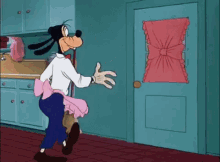 goofy is dancing in a kitchen with a pink apron on his waist .