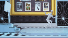 a man in a white suit is dancing in front of a wall with pictures on it