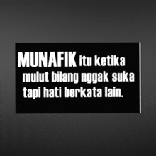 a black and white sign with the words munafik itu ketika mulut bilang nggak suka tapi hati berkata lain