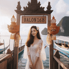 a woman in a white dress stands in front of a sign that says balon168