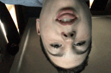 a person 's face is upside down with their tongue sticking out