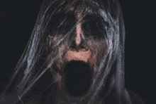 a close up of a ghost with a spider web covering his face .