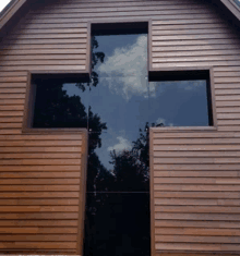 a wooden building with a cross in the middle of it