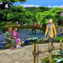 a woman in a yellow jacket is walking in a park with a man and a woman sitting on benches