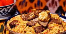 a plate of food with rice and meat on a table .