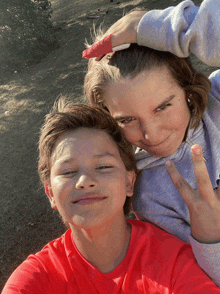 a boy and a girl are posing for a picture together