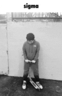 a black and white photo of a person holding a scooter with the word sigma on the bottom