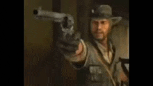 a man in a cowboy hat is pointing a gun at someone .