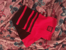 a pair of red and black socks with a label that says tuff on it