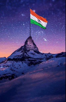 a flag flies on top of a snow covered mountain