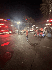 a man stands on a street in front of a cvs store