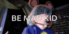 a chuck e cheese mascot is standing in front of a brick wall and says be mad kid